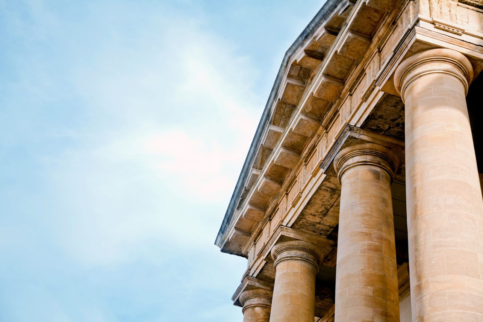 Geldwäschebeauftragter schaut auf ein altes römisches Säulengebäude